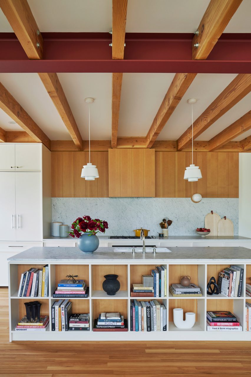 Exposed timber beams within kitchen of house by And And And Studio