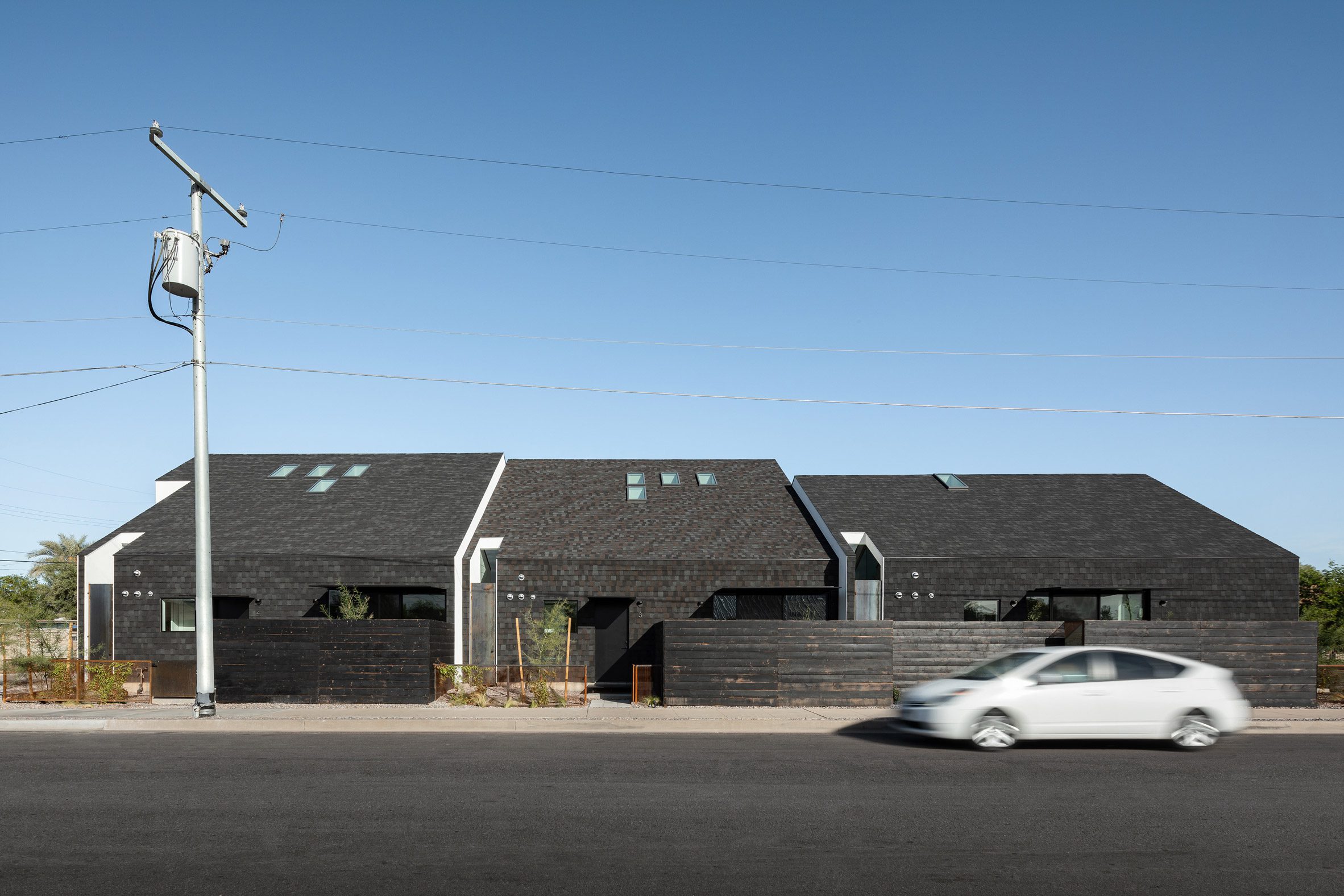 House with a pitched roof clad in asphalt shingles by SinHei Kwok