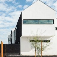White stucco gable end of Polker House by SinHei Kwok