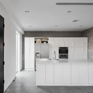 Kitchen with a white island and concrete block walls
