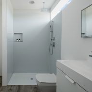 Bathroom with concrete floors and white walls