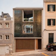 Bak Gordon inserts green-tiled concrete house on sloping street in Lisbon