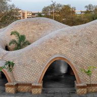 Flowing vaulted roofs top Tarang arts space by The Grid Architects
