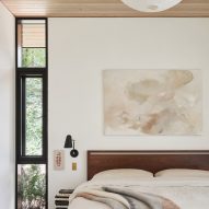 Bedroom with white walls and a timber ceiling
