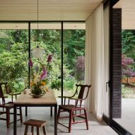 Dining room with floor-to-ceiling windows and a wooden table and chairs