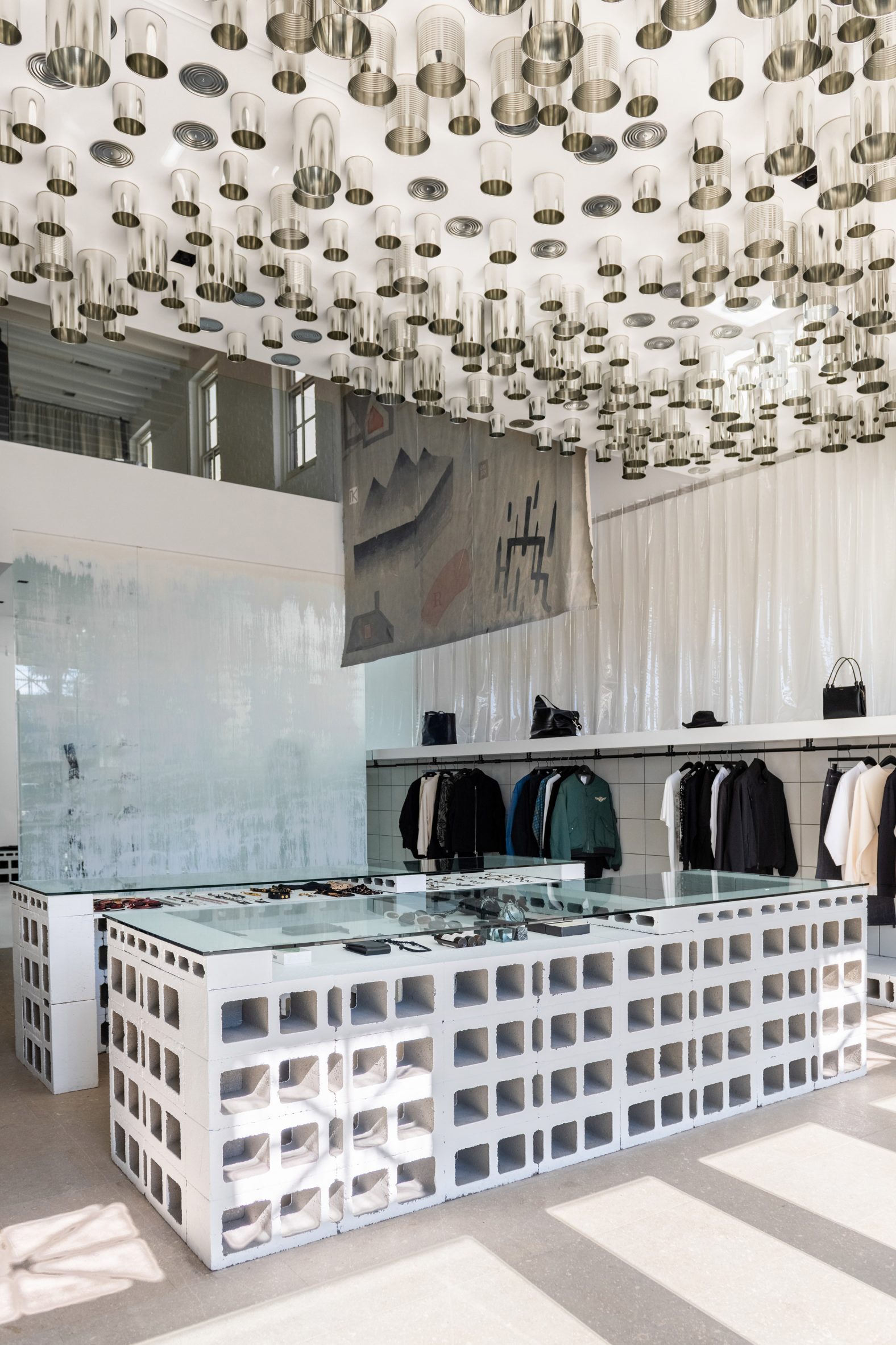 Store with concrete breezeblock displays and metal cans on the ceiling