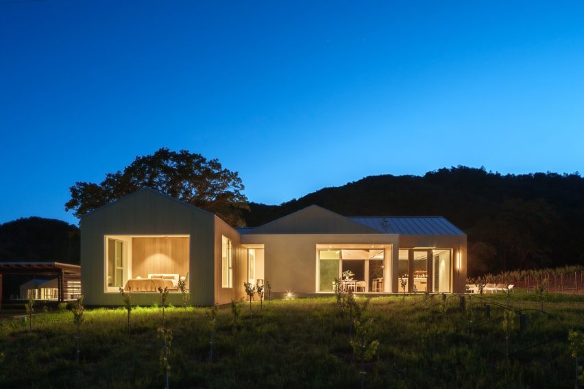 Timber barn house on a Californian far lit up at night