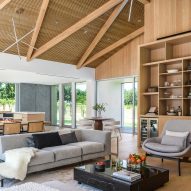 Open-plan dining and living room in a timber barn house in California