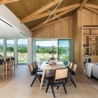 Open-plan kitchen, living and dining room in a timber barn house in California