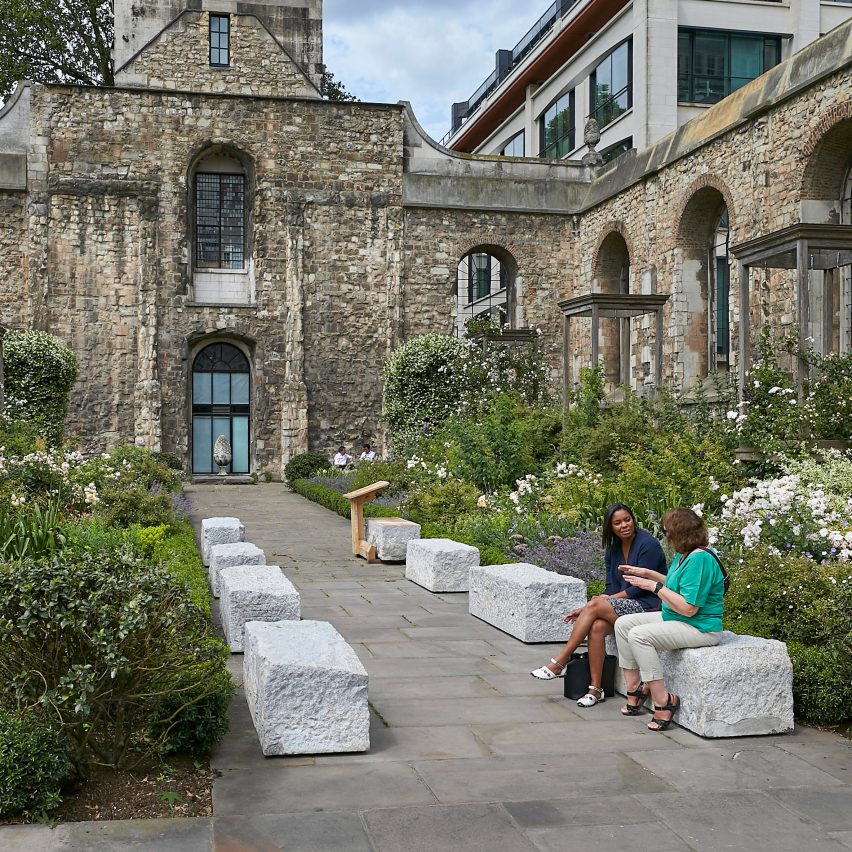 Photo of people sitting on stone blocks