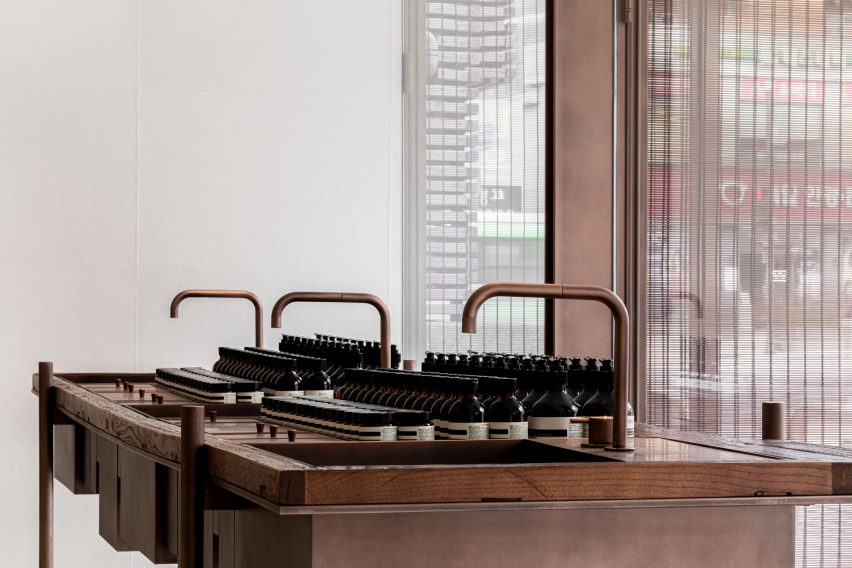 Sleek copper taps within Aesop store