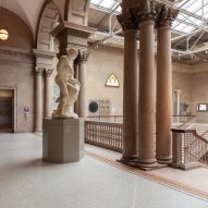 Columns and statue in a large gallery space