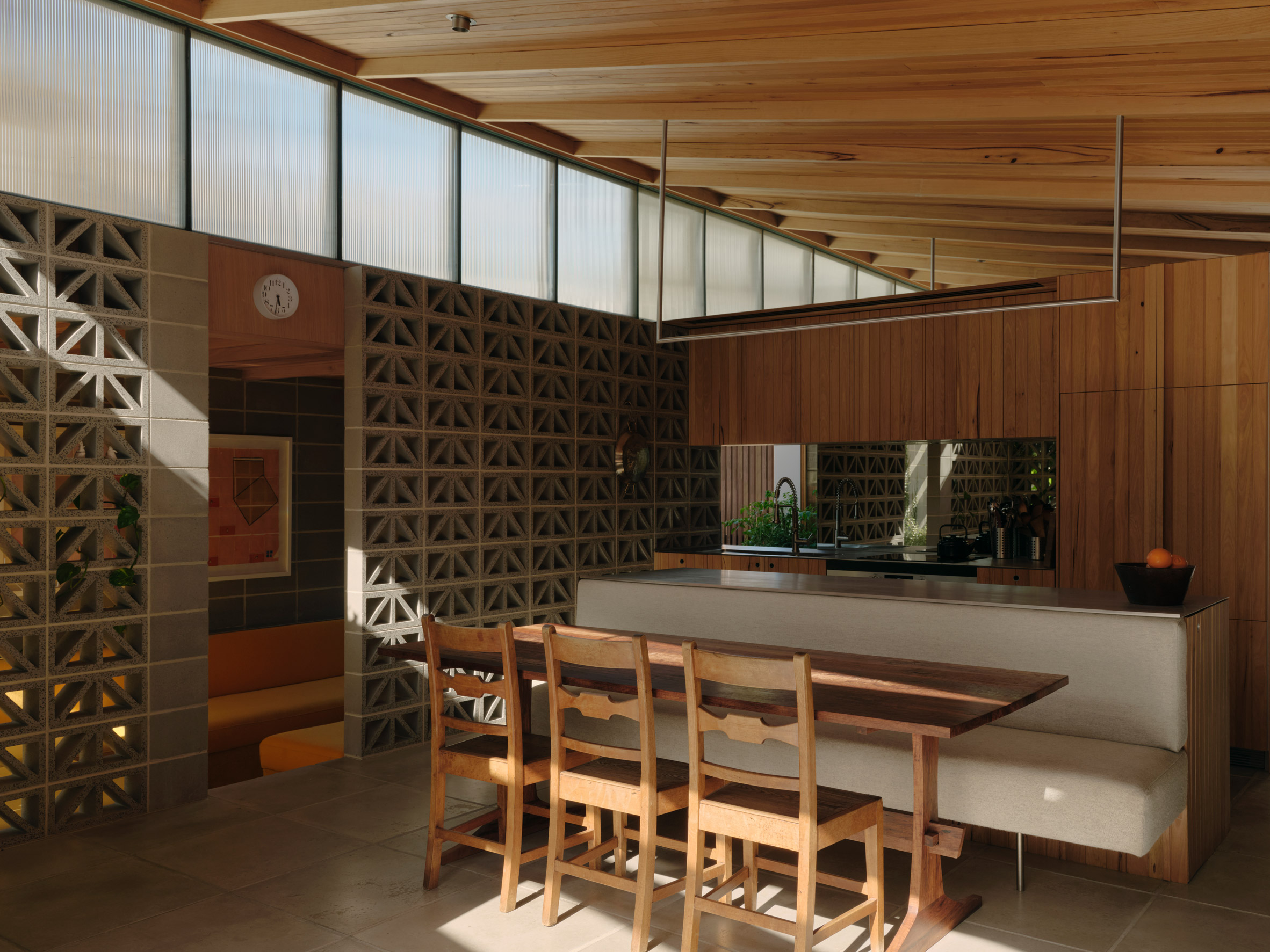 Kitchen with perforated breeze black walls and a timber ceiling