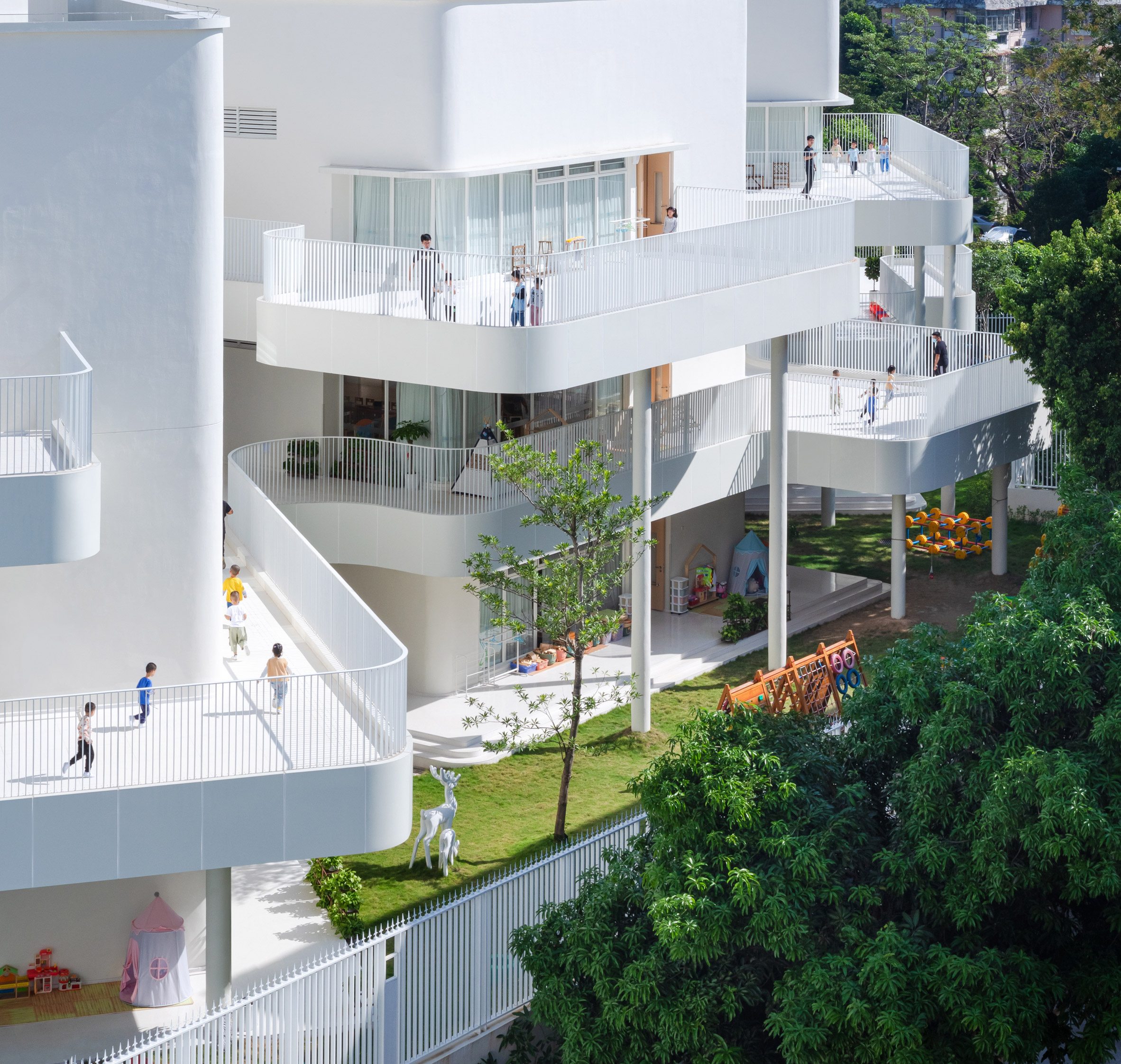 Staggered white balconies at Kindergarten of Museum Forest