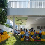 Children playing in a garden at the Kindergarten of Museum Forest by Atelier Apeiron