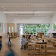 Classroom with white walls and wood flooring at the Kindergarten of Museum Forest by Atelier Apeiron