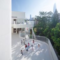 Curving white balconies at the Kindergarten of Museum Forest by Atelier Apeiron
