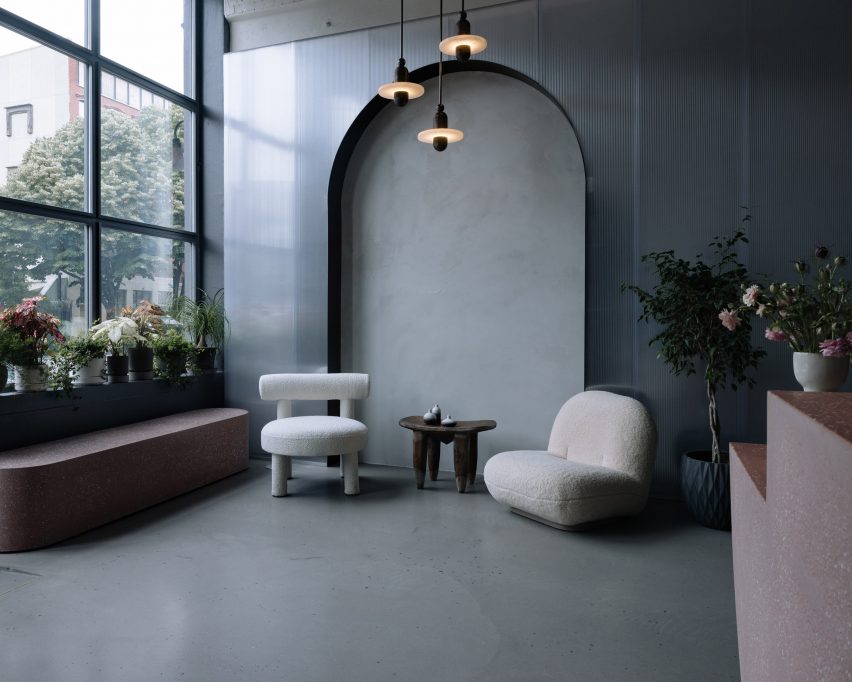 Pink concrete furniture either side of a seating area