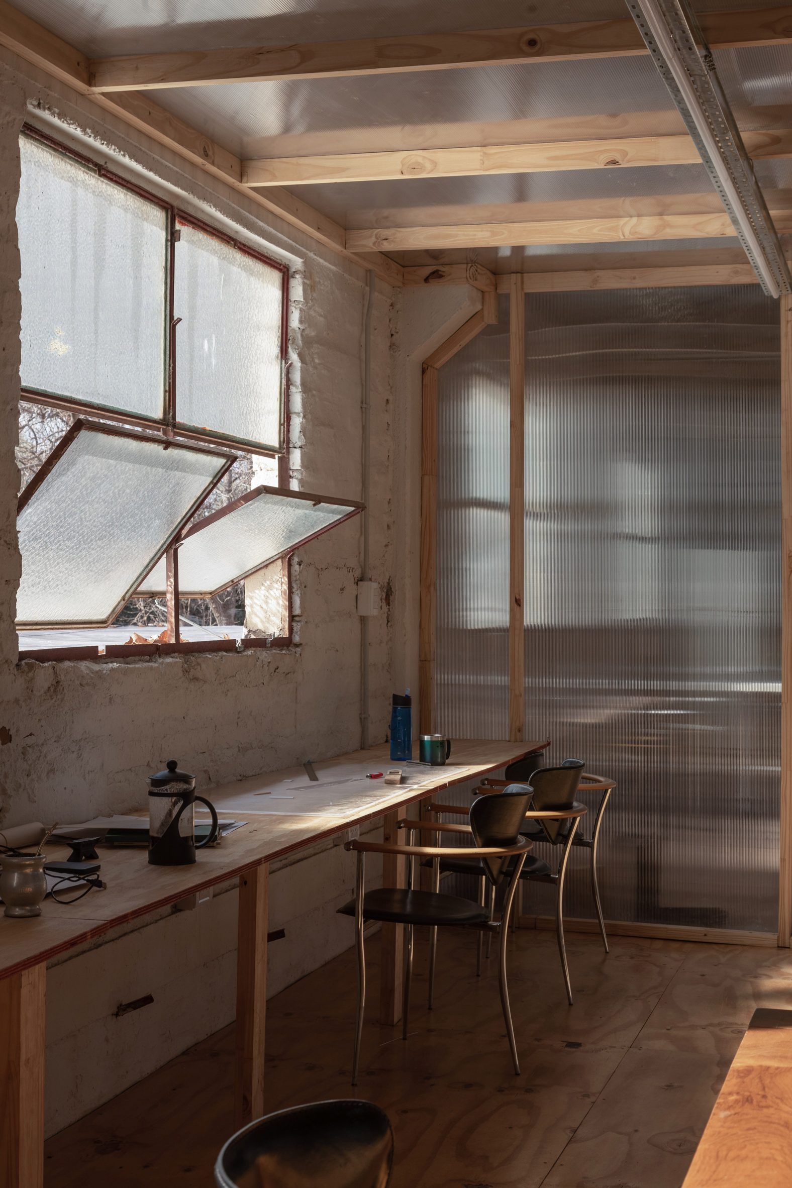 Polycarbonate walls and desks with windows in brick walls