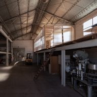 Atelier Industrial installs minimalist office within warehouse in Argentina