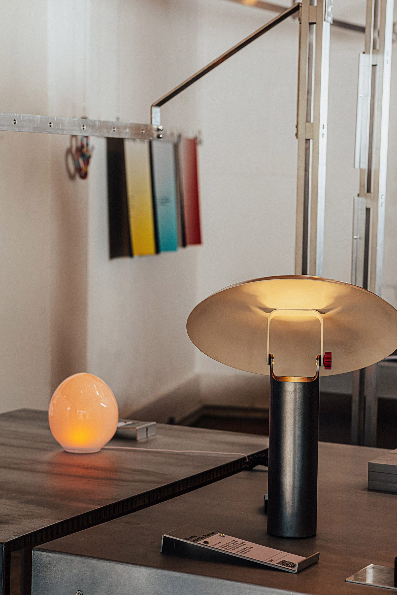 A metal lamp next to a small egg-shaped lamp