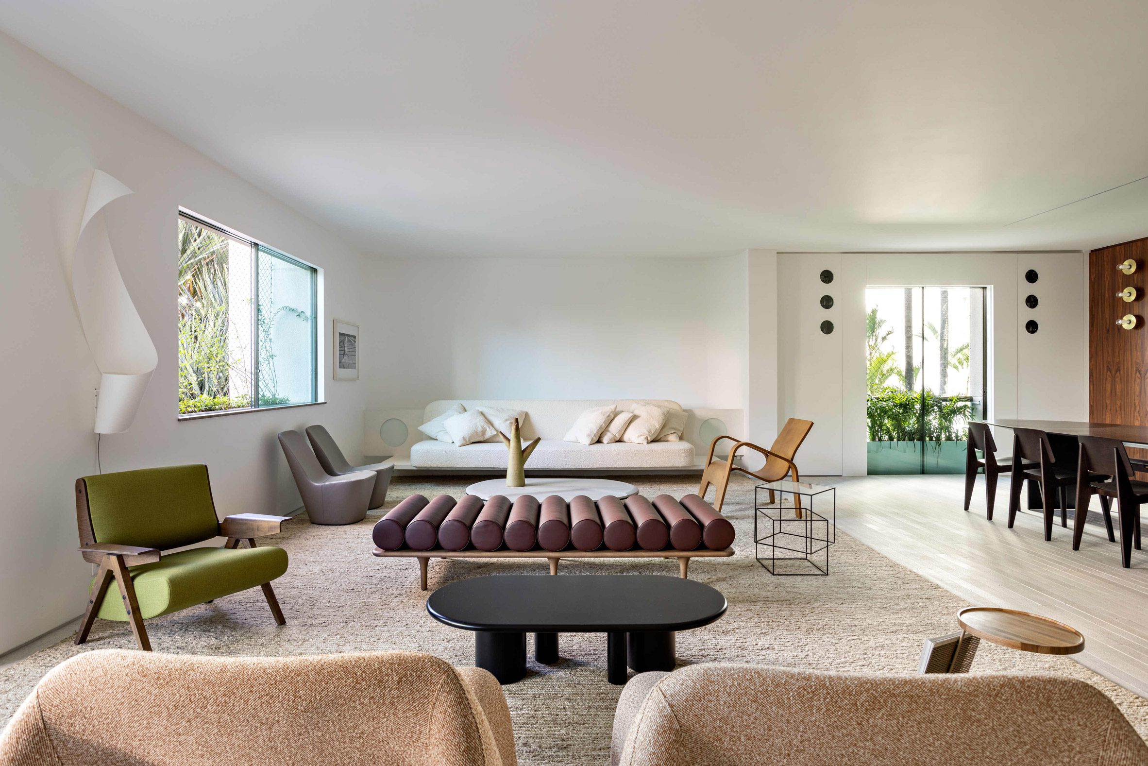 Open living room with a variety of midcentury and contemporary furniture