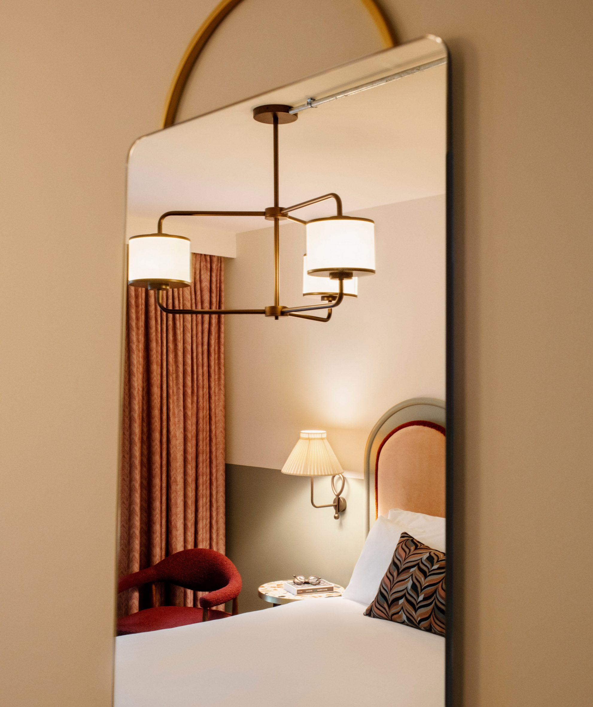 Hotel bed as seen through a mirror