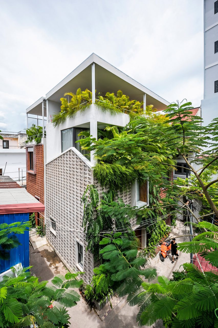 Plant-covered home made from perforated cement blocks by Bloom Architecture