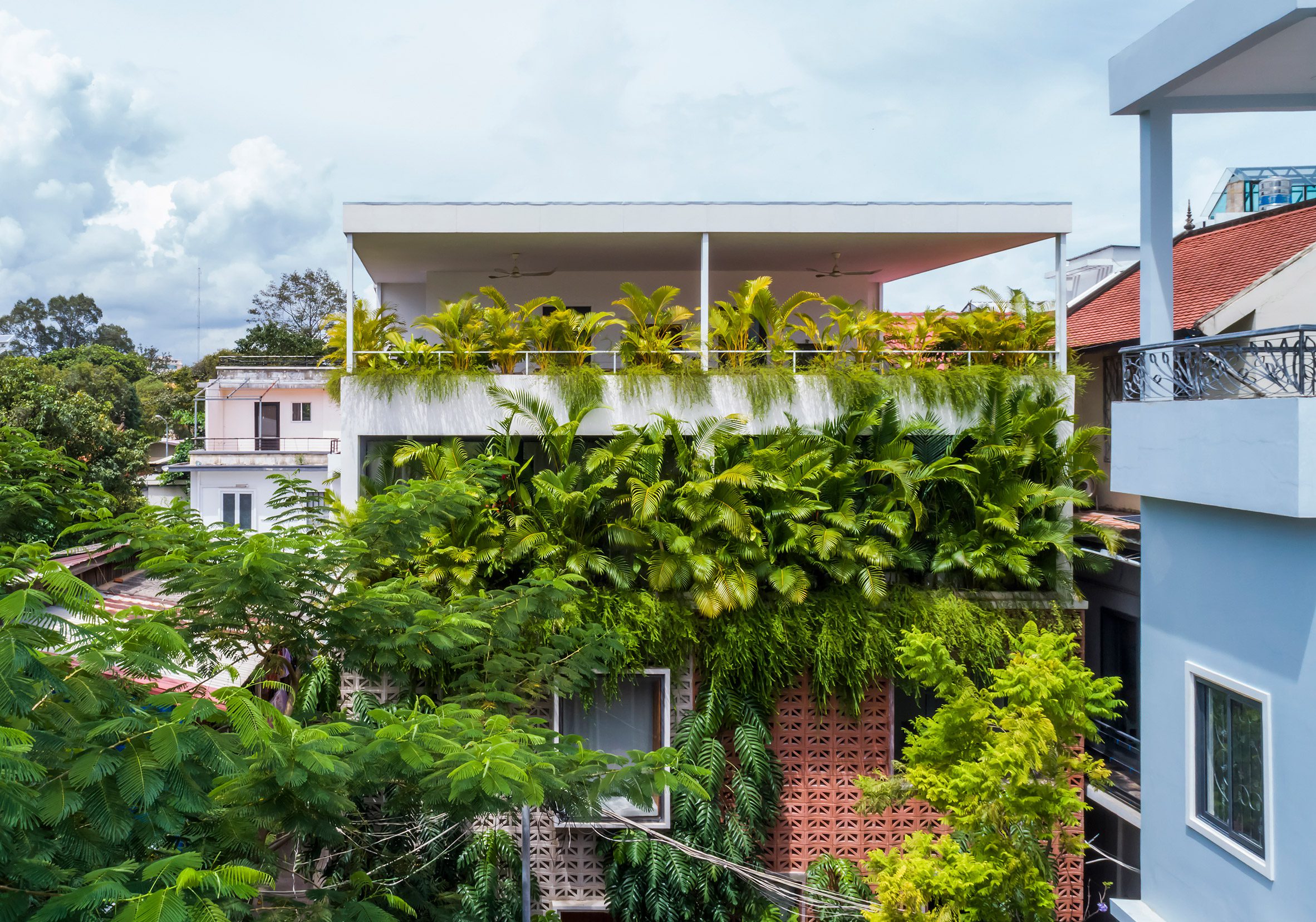 Plant-covered home in Cambodia made from perforated cement blocks by Bloom Architecture
