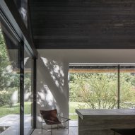 Lounge chair and stone breakfast bar in the minimalist Villa VD by Britsom Philips