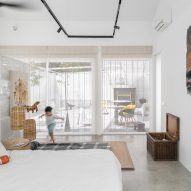 Bedroom with white walls, concrete floors and glazed sliding doors