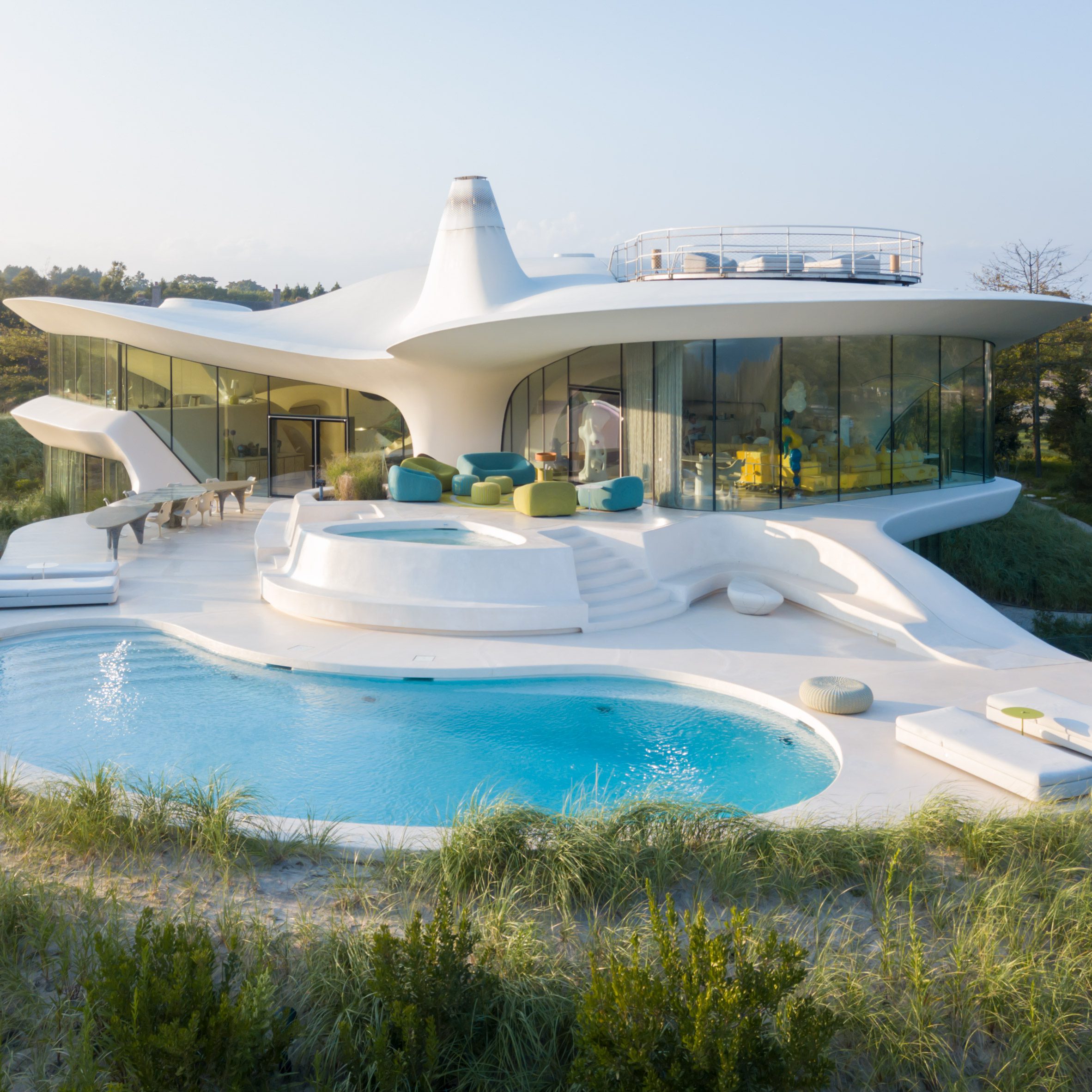Whit modernist house with swimming pools in sand dune