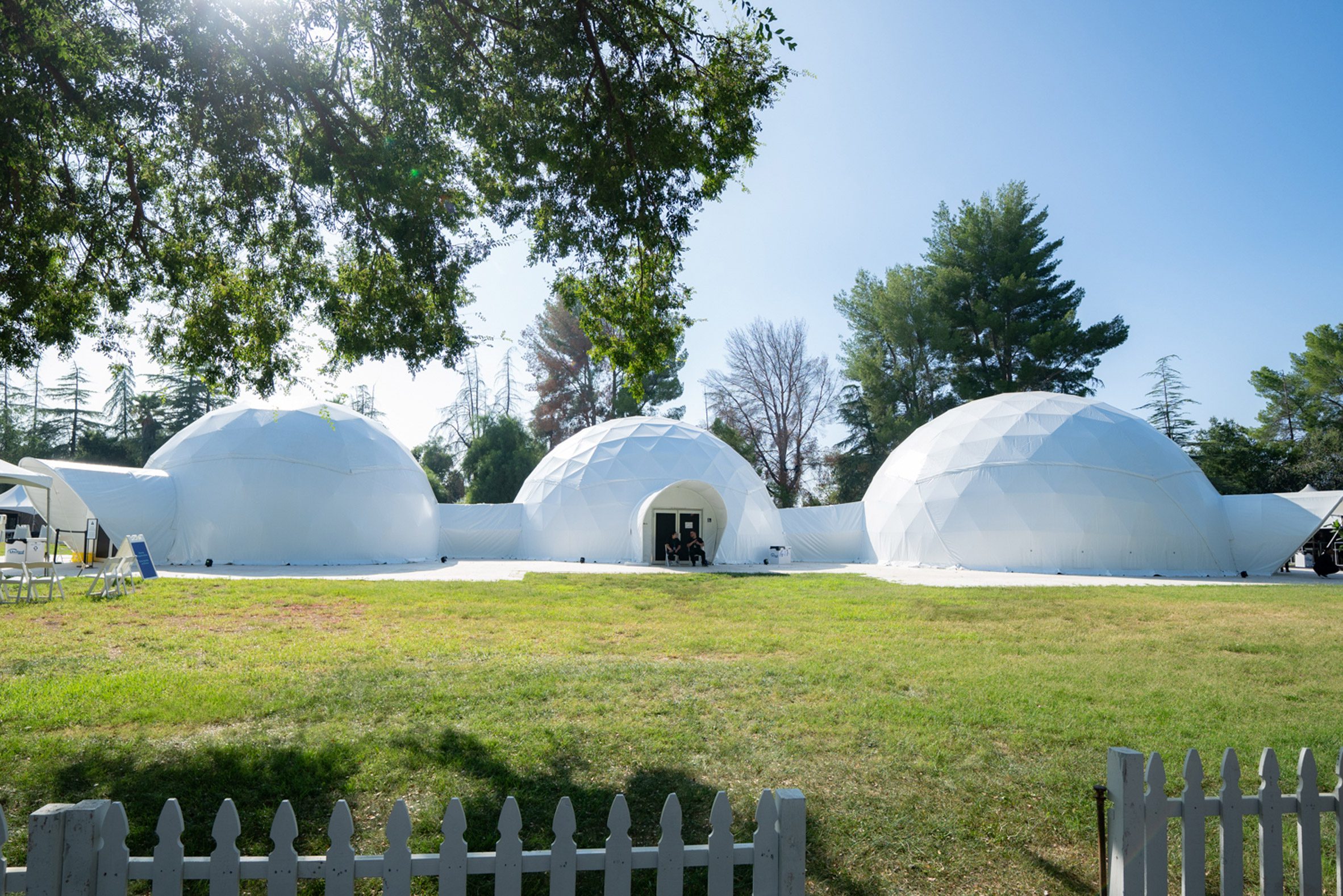 Three white geodesic domes