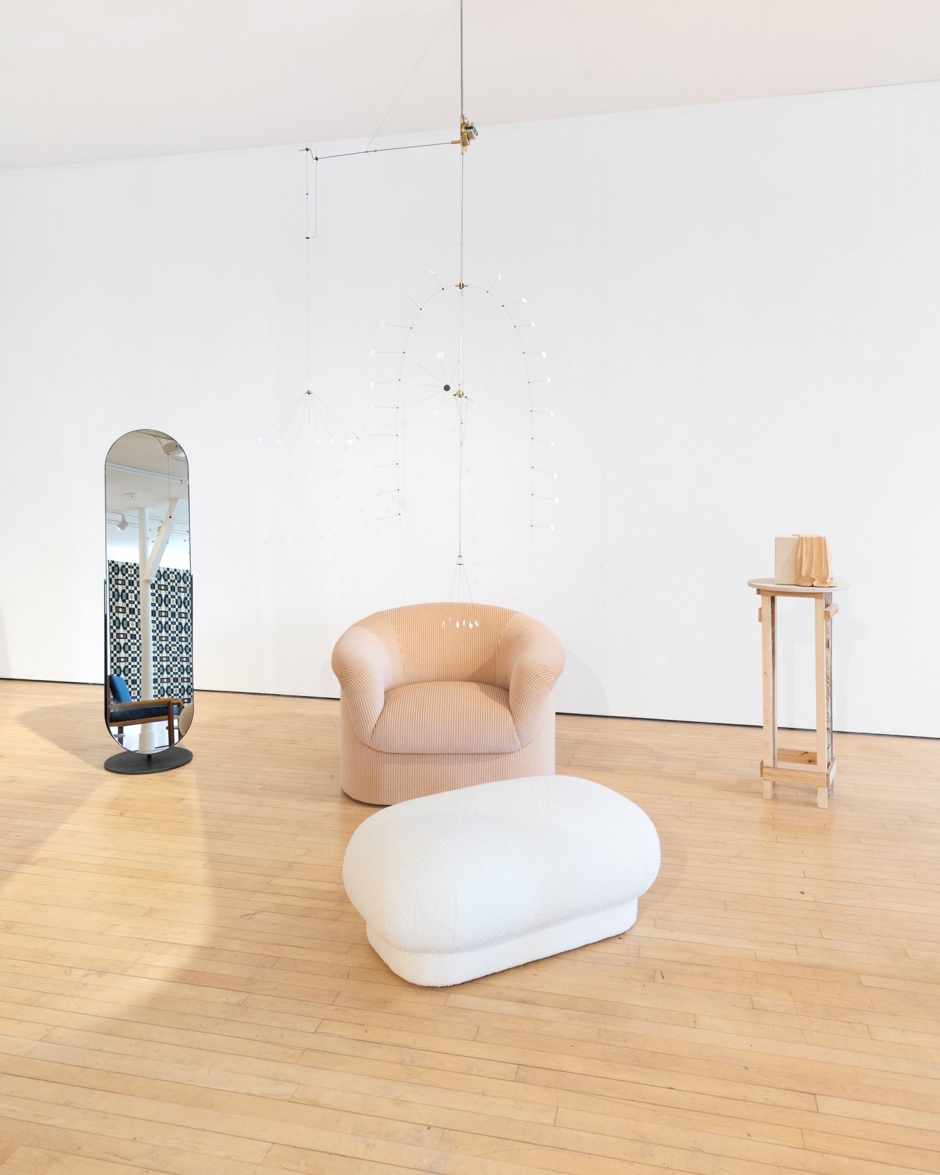 The Port Free Mirror by Novocastrian alongside the Roll Top Chair and Roll Top Ottoman by Sedilia with Song 1 Awe-to Series by William Waterhouse hanging from ceiling and Draped in Wood by Silje Loa on a plinth