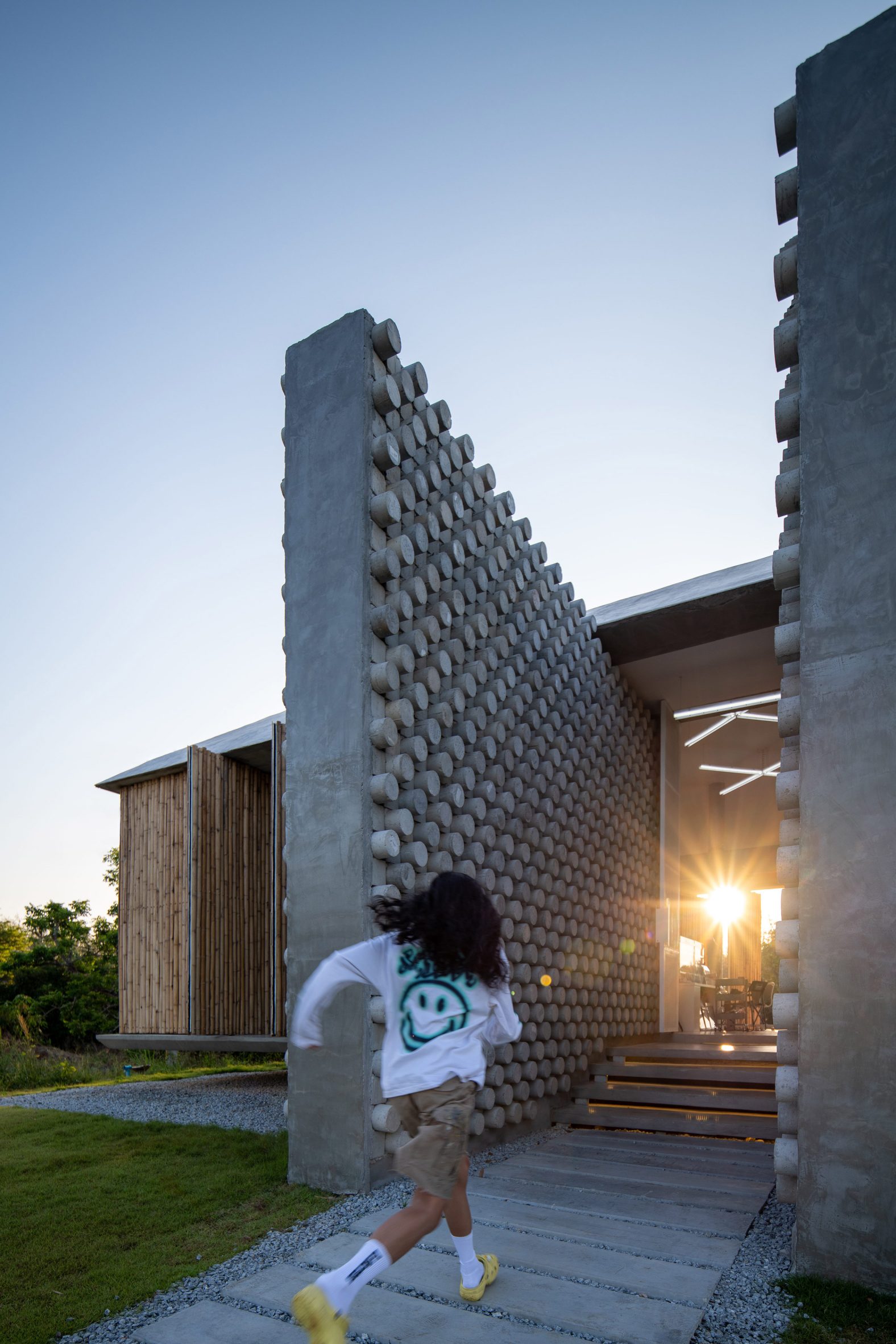 Entrance to Furnish Studio framed by concrete walls