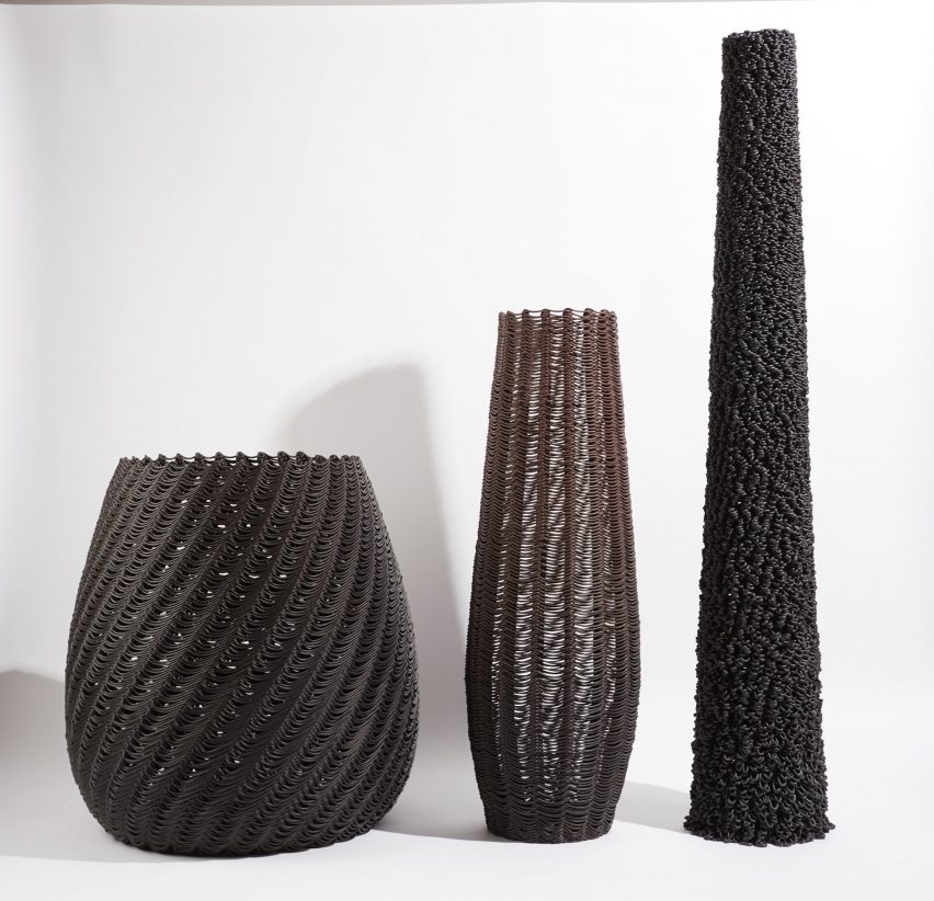 Photo of three basket-like forms, one short and stout, one long and thin and one in between, all made of loops of 3D-printed plastic in black or brown colours