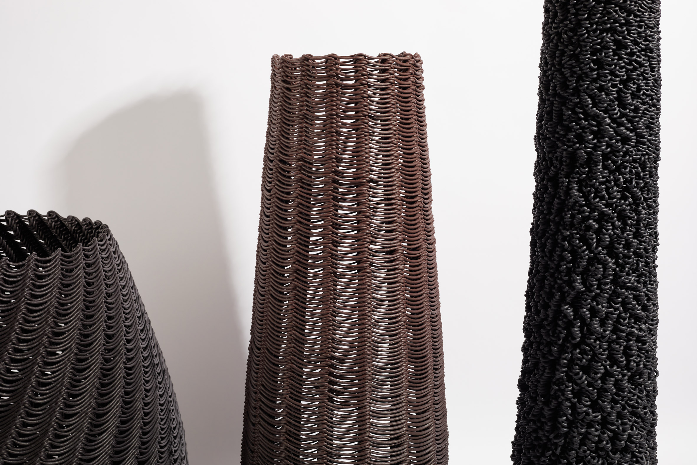 Photo of the forms in the Digitally Woven project in close-up showing basket-like woven structure in plastic