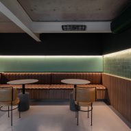 Home bar with brown leather seats and green walls