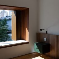 Wooden seat in a window at Casa Yuji in Sao Paulo by Goiva