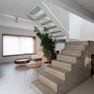 Open-plan living space with a concrete block staircase
