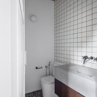 Bathroom with square white wall tiles