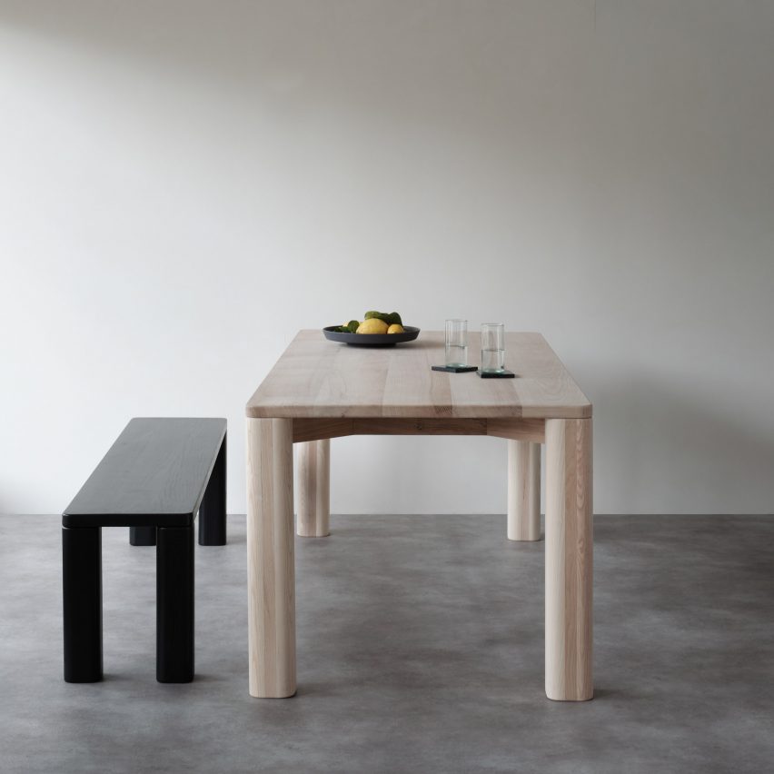 Natural wooden dining table and black bench by Goldfinger and the Tate Modern