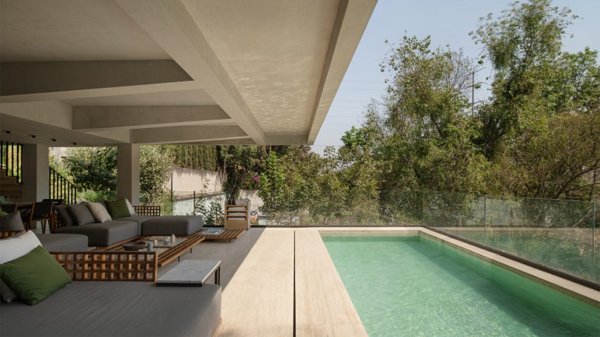 Outdoor pool by a concrete house in Mexico by Taller David Dana