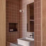 A bathroom made with soft pinkish tiles