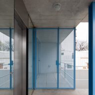 Blue steel column and blue metal mesh gate in a concrete apartment building