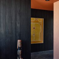 Interior room with terracotta-toned ceiling and blackened wood walls