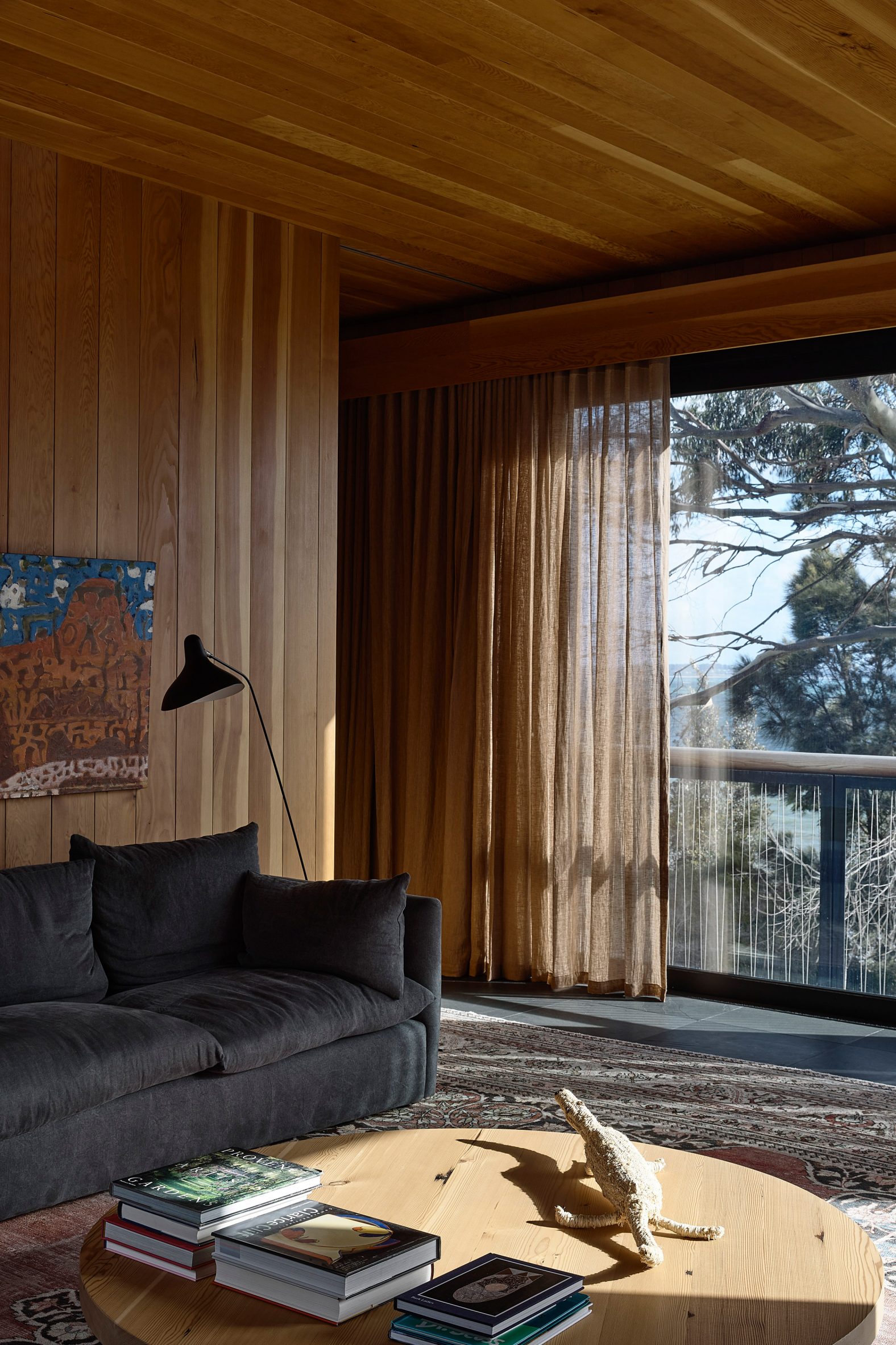 Timber-clad living room with views of the sea at Somers House by Kennedy Nolan