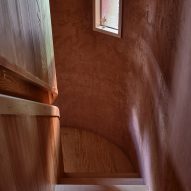 Stairwell in a rounded ochre-rendered structure