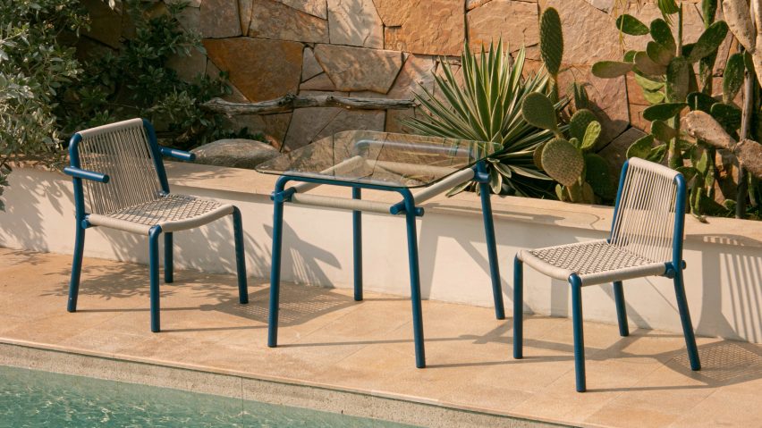 Photograph of blue and beige chairs by pool