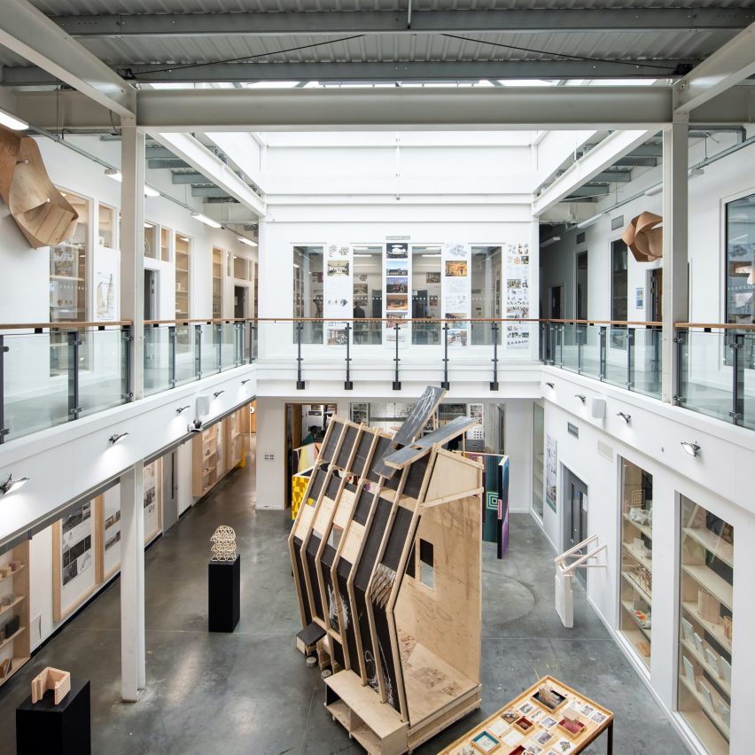 a photograph of the inside of a university campus displaying student architecture work